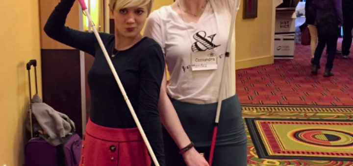 casey and cassandra pose in a hallway, making duck faces and holding up their white canes