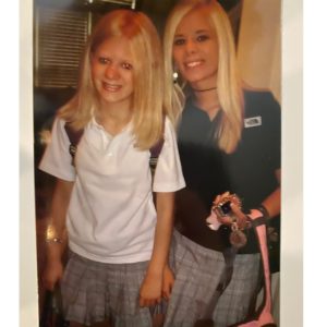 teenage casey and her older sister lynley. casey is wearing a baggy white polo shirt and sporting the frosty pink lips and bronzer look she mentions in the podcast