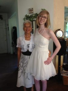 cass wearing a white dress standing with her late grandma. cass is extremely thin and both women are smiling