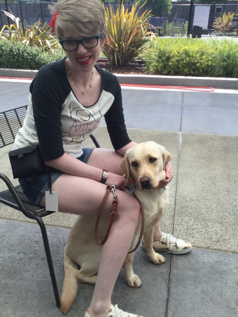 cassandra with a young romana. cass is in a chair with ro between her legs as they both turn to look at the camera