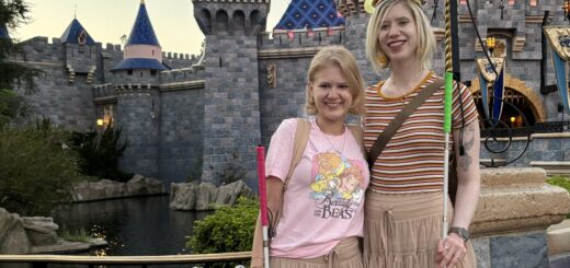 case and cass pose in front of the sleeping beauty castle in disneyland. they smile and wear matching beige tulle miniskirts